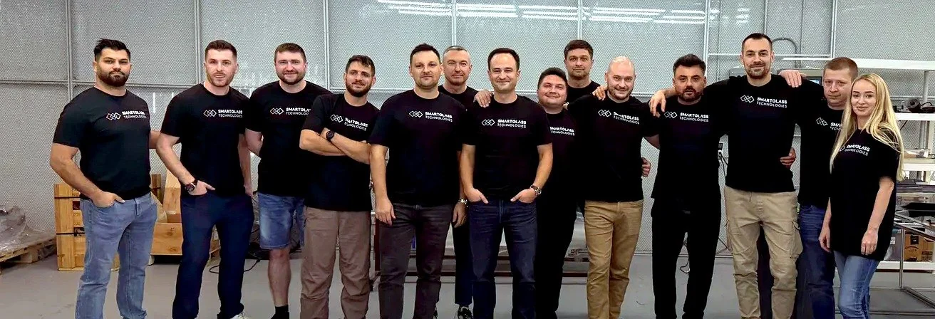 The Smart Glass Technologies team standing together in the workshop